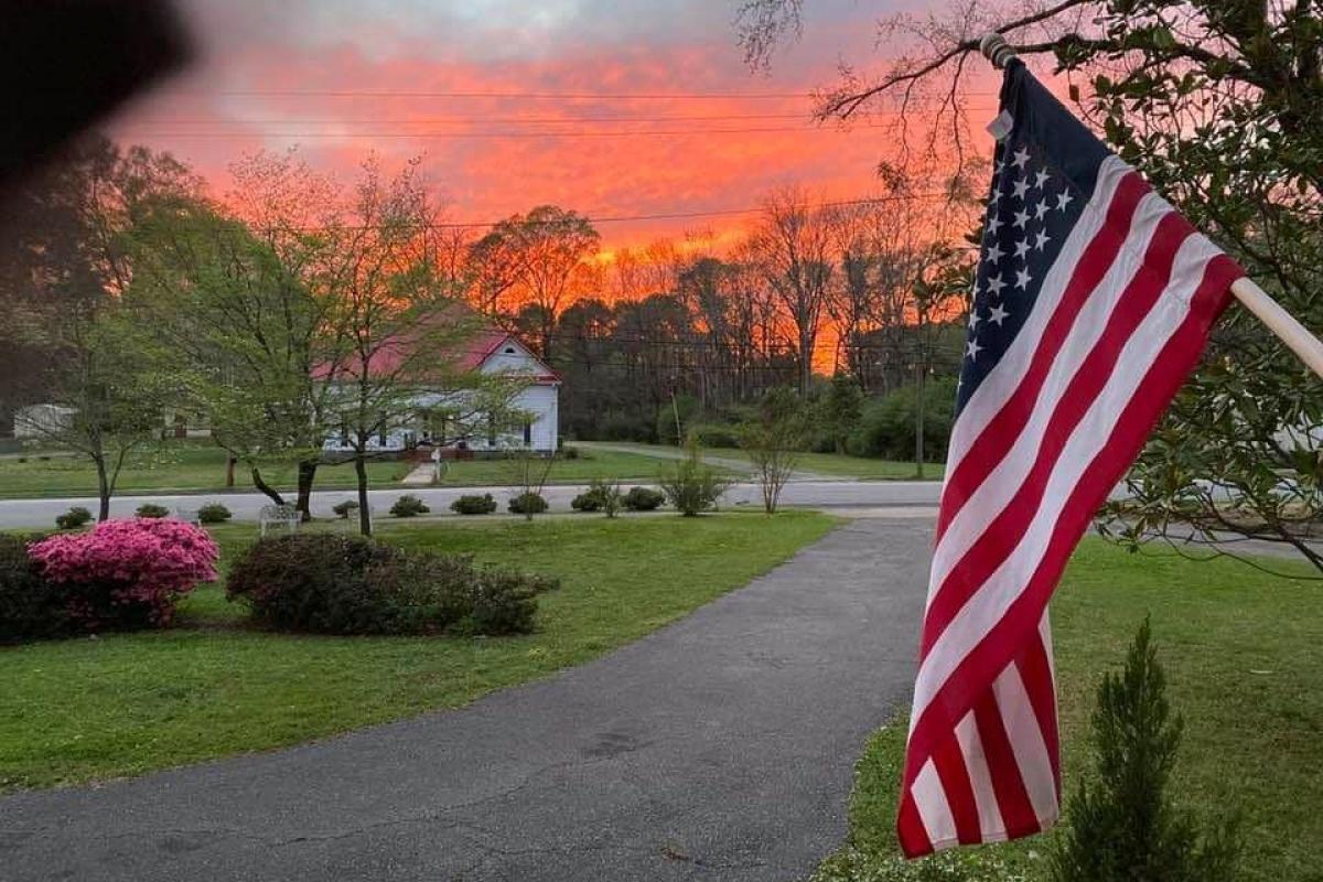 American flag in front of sunset