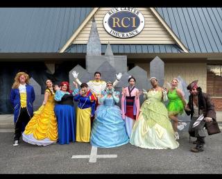 Rux Carter Insurance Agency employees dressed as princesses and princes for Halloween