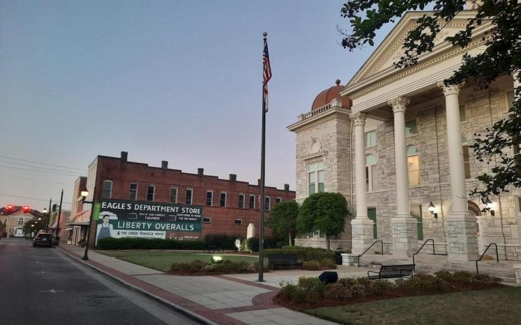 Shelby Co. Courthouse with Flag pole and mural in background. 
